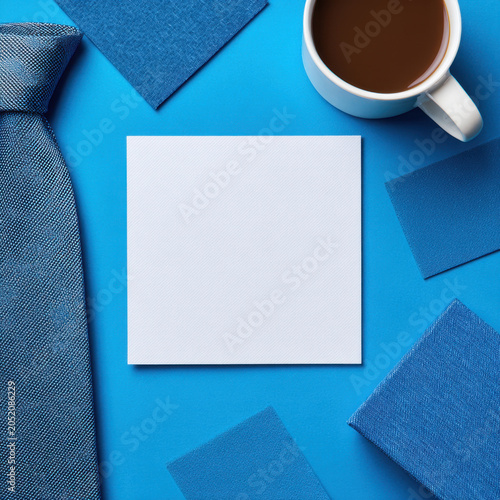 Blank card blue background coffee cup necktie fabric workspace office copy space flat lay invitation