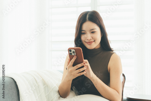 Woman Checking Blood Glucose Level During Telehealth Consultation at Home