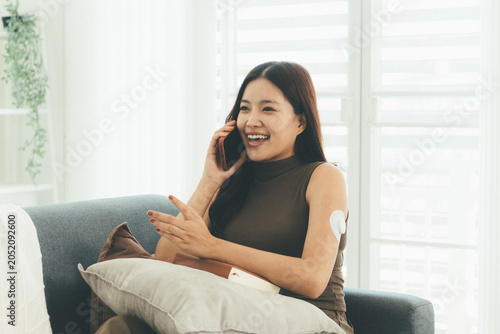 Woman Checking Blood Glucose Level During Telehealth Consultation at Home