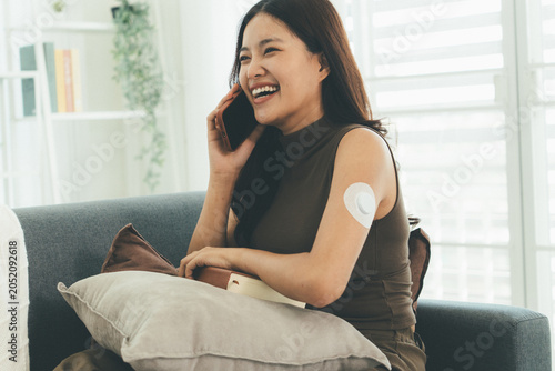 Woman Checking Blood Glucose Level During Telehealth Consultation at Home