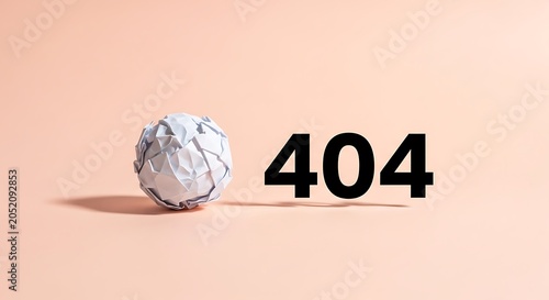 Crumpled paper ball next to a printed 404 error