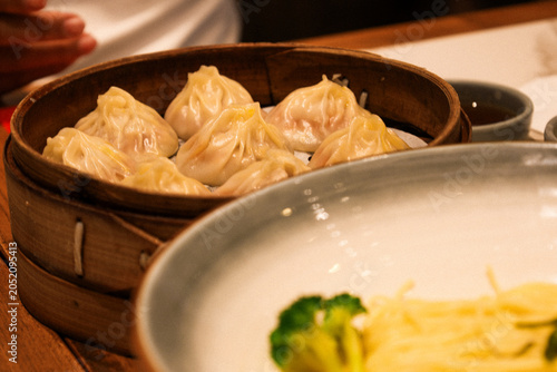 Cuadro en lienzo Freshly steamed crab roe Xiao Long Bao in a hot bamboo steamer.