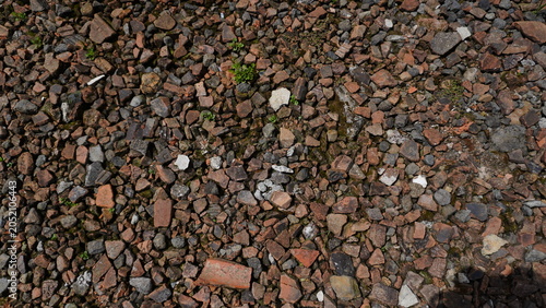 Broken roof tile fragments scattered on the ground Close-up of broken roof tile fragments scattered on the ground, showcasing rough textures, construction debris, and signs of damage or renovation