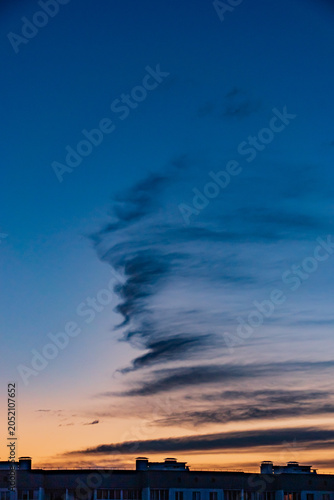 Canvas Print Majestic twilight clouds dance across the darkening sky above a quiet urban land