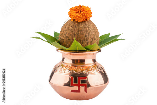 Traditional copper kalash pot with coconut and marigold flower for hindu religious rituals isolated on a black background, for worship