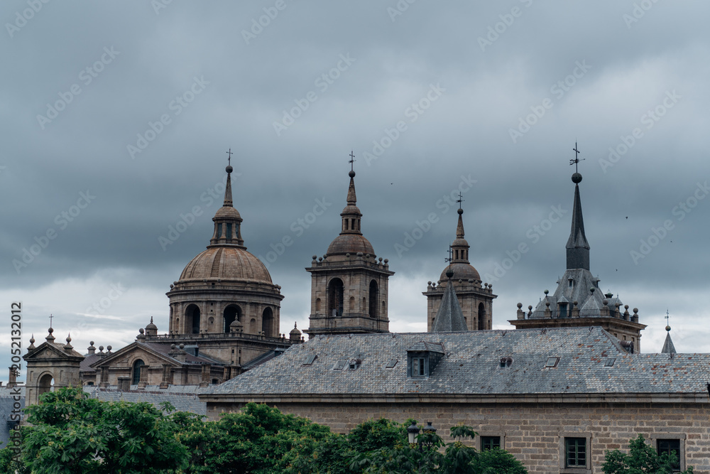 Obraz premium El Escorial monastery spires under a dramatic sky