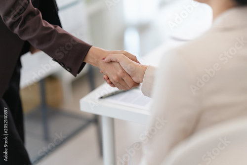 Photos Two business people shaking hands to finalize job offer agreement in professiona