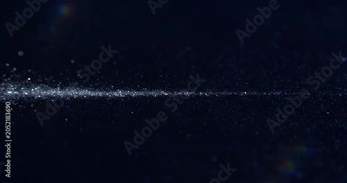 Abstract glowing blue particles flowing in dark space, futuristic technology background
