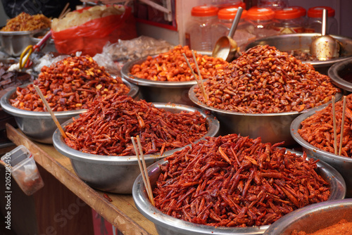 A taste of Guizhou. Bold and spicy local chili dishes at the historic Qingyan Ancient Town market, China.