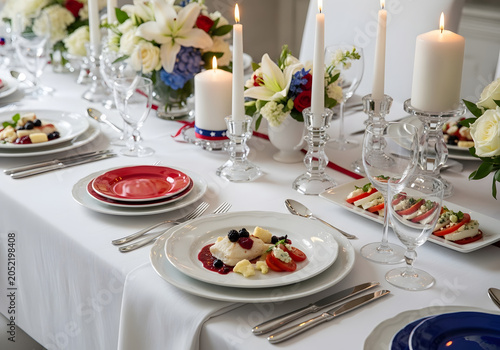 A beautifully set table with plates, glasses, and candles, adorned with flowers, showcasing a delicious meal in a elegant indoor setting with food, tablecloth, silverware, decorations, and linens.