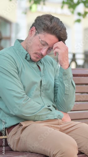 Man Feeling Worried While Sitting on Bench Outdoor, vertical video