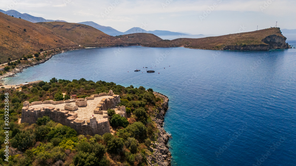 Fototapeta premium aerial drone of Porto Palermo Castle on its coastal peninsula next to the calm blue waters of the bay in southern Albania