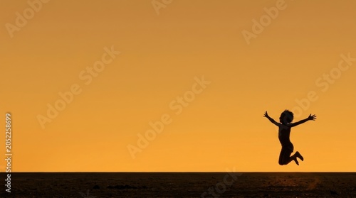 Children Silhouettes Running Happily Towards Sunset Across African Golden Plains