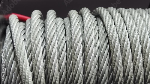 Steel cables are stacked neatly and ready for use at a construction site in the afternoon light with tools in the background