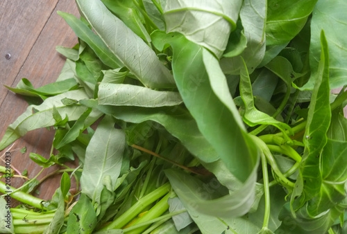 bunch of spinach on a wooden table