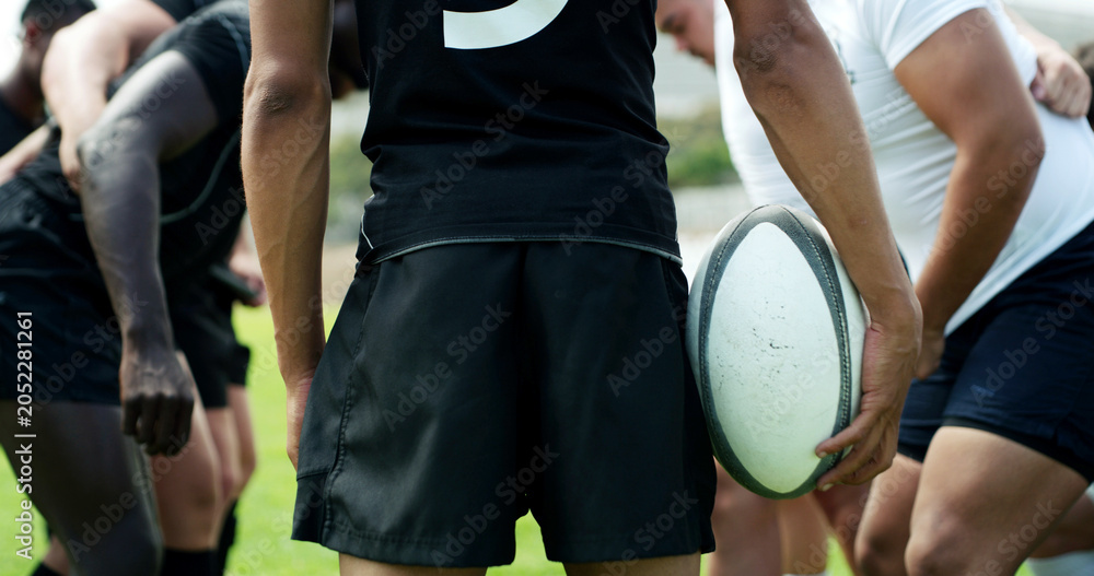 Fototapeta premium Rugby, practice and hands of man with ball on field for tournament match, teamwork and competition. Sports, athlete and players with exercise, support and fitness for training, performance or contest