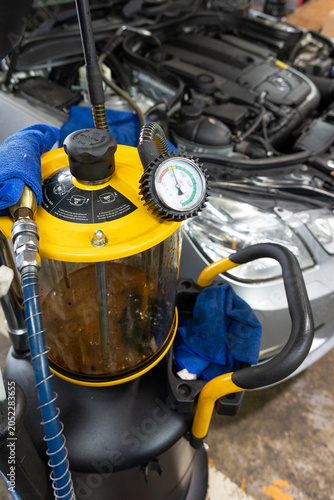 Auto mechanic working in repair shop garage. Vehicle maintenance and inspection service