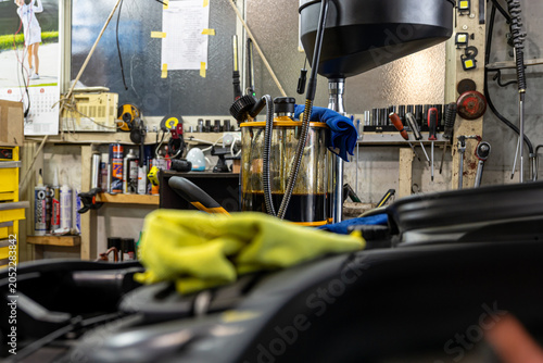 Auto mechanic working in repair shop garage. Vehicle maintenance and inspection service
