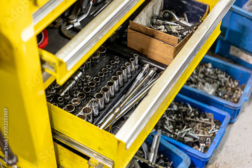 Auto mechanic working in repair shop garage. Vehicle maintenance and inspection service