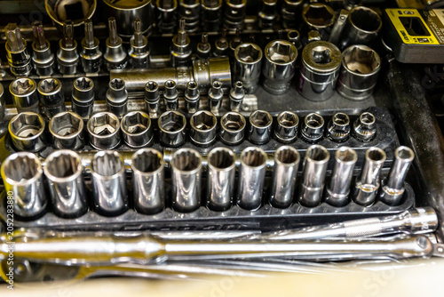 Auto mechanic working in repair shop garage. Vehicle maintenance and inspection service