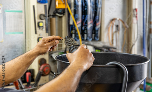 Auto mechanic working in repair shop garage. Vehicle maintenance and inspection service