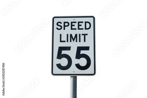 Rectangular white speed limit sign with black text reading 55, mounted on a metal pole, isolated on a solid black background, for traffic