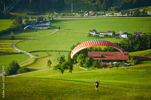 Obraz na płótnie Solo Paraglider Enjoying a Breathtaking Mountain View