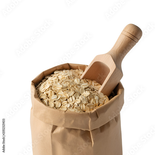 A wooden spoon scooping grains from a brown paper sack