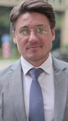 Middle Aged Businessman Shaking Head as Yes Sign, vertical video