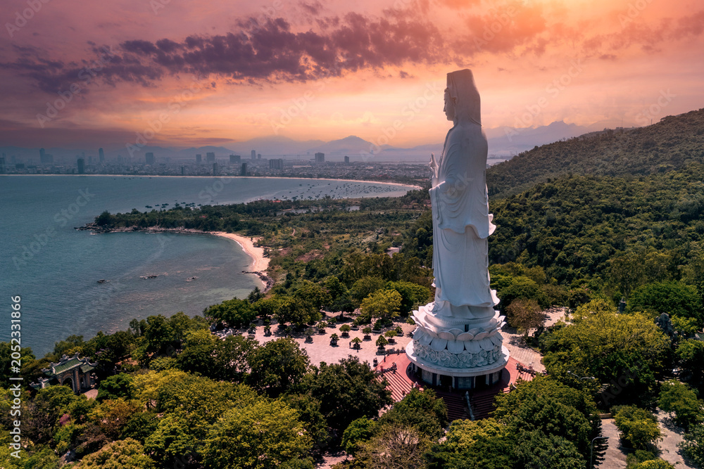 Obraz premium White Buddha statue Lady Buddha at Linh Ung Pagoda, Danang, Vietnam in sunset beautiful clouds