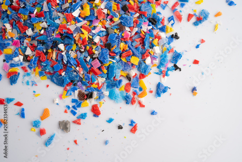 Photos Plastic colorful pieces recycling shredded for industrial use.