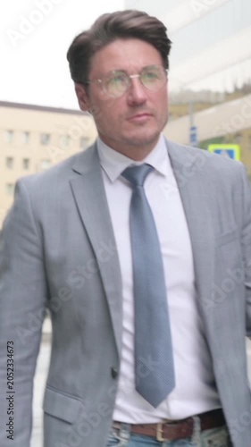 Close up of Middle Aged Businessman Walking on Street, Slow Motion, vertical video
