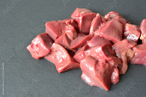 Konstfotografi Raw turkey Liver Cubes on Dark Background copy space