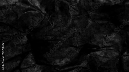 Dark, dynamic texture of crumpled paper. 4K