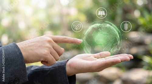 Business Person Holding Digital Green Earth Globe with Sustainability Icons