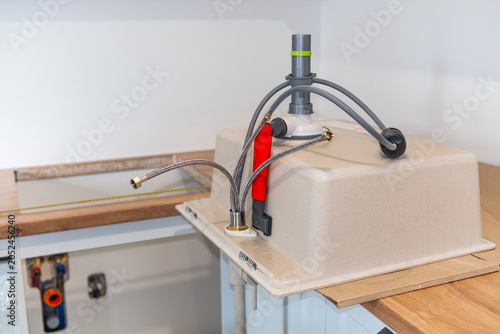 Tableau sur toile Undermount sink installation with plumbing connections and drain assembly