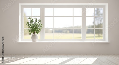 Bright room with large window and plant.