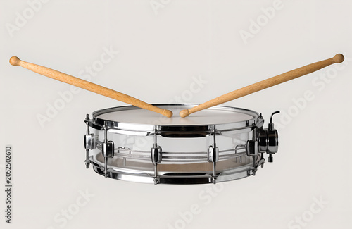 Snare drum with wooden sticks on light grey background  