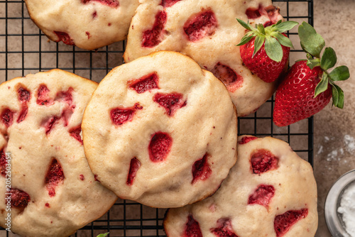 Shortbread cookies with strawberries on a baking rack close up. Summer homemade pastries top view