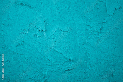 Turquoise plaster wall texture with rough application