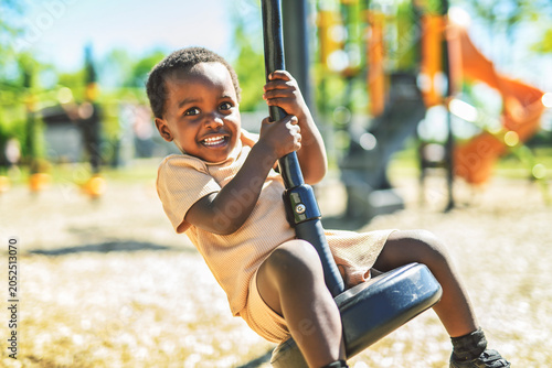 Happy young american child on playground this summer season