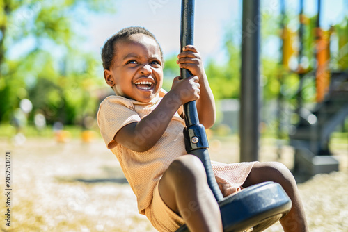 Happy young american child on playground this summer season