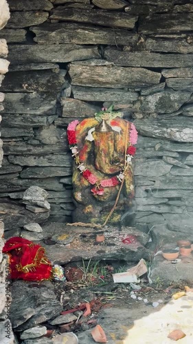 Ancient-style Lord Ganesha idol carved in stone, capturing the essence of devotion and the rich heritage of Hindu traditions.