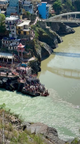 Mountain town and bridge overlooking the meeting point of Alaknanda and Bhagirathi rivers.