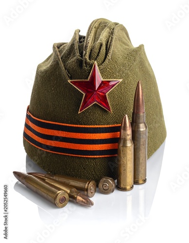 A green military-style bag with a red star and orange stripes, accompanied by scattered bullets