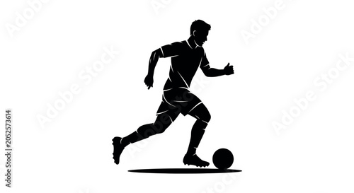 Silhouette of a soccer player kicking a ball