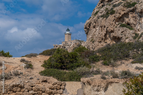 Stone Lighthouse on Rocky Cliff