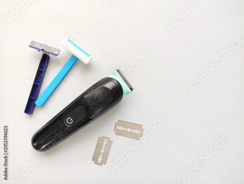 Electric trimmer and disposable razors for body grooming and hair removal. Modern shaving tools for personal care and hygiene.