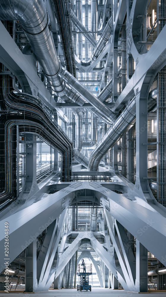 Obraz premium Intricate industrial structure with metallic pipes and beams creating a dynamic view.