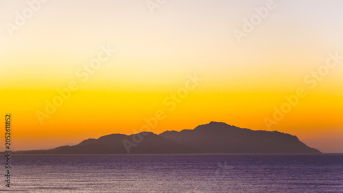 A magical sunrise over the sea with Egyptian resort hotels lining the coast. vibrant romantic resort landscape.